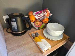 a table with a coffee pot and a plate of food at Mizpah Bed & Breakfast near Ben Nevis Highlands in Roybridge