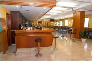 a bar in a restaurant with stools at Extremadura Hotel in Cáceres +29 photos