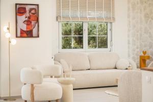 a living room with a couch and a window at Seaview Garden Villa - Heated Pool & Sauna in Stalos