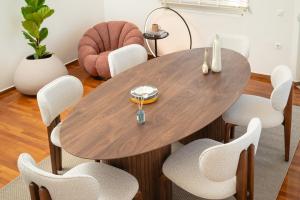 a wooden table and chairs in a room at Seaview Garden Villa - Heated Pool & Sauna in Stalos
