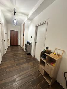 a hallway with white walls and a wooden floor at Dante appartamento in Fagnano Olona