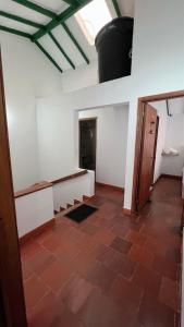 a room with white walls and a red tile floor at Alta Vibracion Casa Boutique in Villa de Leyva