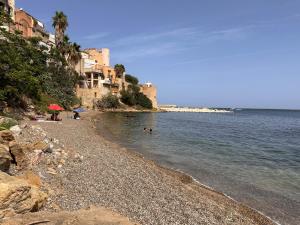 a group of people swimming in the water on a beach at Fantastic sea & harbour view Nino Bixio in Castellammare del Golfo