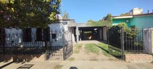 an entrance to a house with a fence at La Casita de Lucía in Almafuerte