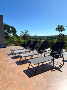 a row of lounge chairs sitting on a patio at Rancho Bela Vista in Alexânia