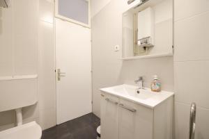 a white bathroom with a sink and a toilet at Quattro Cantoni Apartment in Zadar