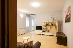 a living room with a couch and a television at Quattro Cantoni Apartment in Zadar