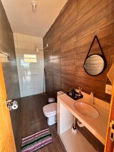 a bathroom with a sink and a toilet and a mirror at Rancho Bela Vista in Alexânia +13 photos