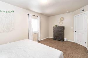 a bedroom with a bed and a dresser and a window at Cozy 1Bdrm•Self Check-in•Downtown in Salt Lake City +9 photos