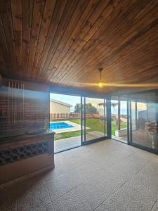 a house with a large sliding glass door to a pool at Villa Barros in Câmara de Lobos