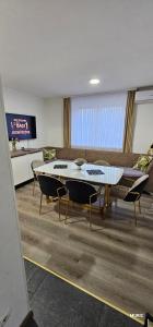 een woonkamer met een tafel, stoelen en een bank bij Apartmani MURIC Ljubljana in Ljubljana +96 foto's