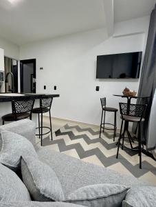 a living room with a couch and a table at Apto 01 casal praia e vista montanhas in Governador Celso Ramos