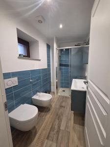 a bathroom with a toilet and a sink at Mirtillo & Margot in Cambiano +6 photos