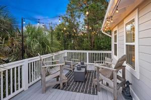 a porch with chairs and a table and lights at Sweet Bay on 30A in Seagrove Beach