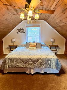 a bedroom with a large bed in a attic at Lake Front Sunset | New Deck | Kayaks | Canoe in Salisbury