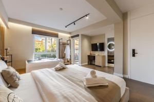 a bedroom with a large bed with towels on it at Zoe's Villa by PS in Durrës