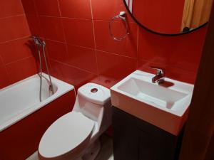 a bathroom with a white toilet and a sink at Cabañas Mirador de Maitencillo 2 in Maitencillo