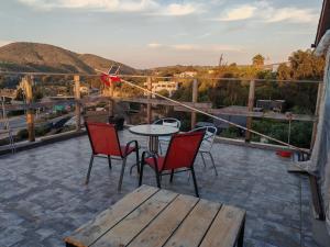 a patio with a table and chairs on a roof at Cabañas Mirador de Maitencillo 2 in Maitencillo