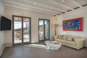 a living room with a couch and a table at Avera Villas in Parikia