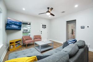 a living room with a couch and a tv at Lone Star Landing in San Antonio