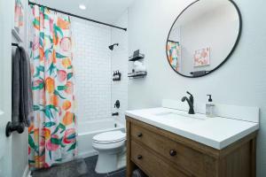 a bathroom with a sink and a toilet and a mirror at Lone Star Landing in San Antonio +23 photos