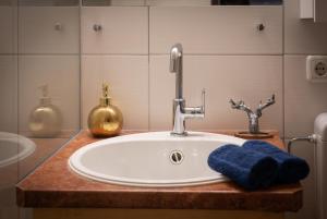 a bathroom sink with a blue towel and a faucet at Dachstein Blick in Bad Goisern