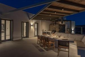 a kitchen and dining room with a table and chairs at Avera Villas in Parikia