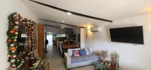 a living room with a christmas tree and a tv at Casa de Playa Salgar in Puerto Colombia