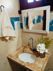 a bathroom counter with a sink and a mirror at Casa Barra Nova in Cascavel