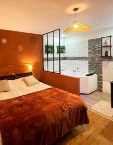 a bedroom with a bed and a bath tub at Nali Room in La Vespière +14 photos