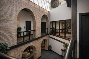a brick hallway with arches and windows in a building at Brick & Bed Riverfront Lofts, T 302 in Saint Louis