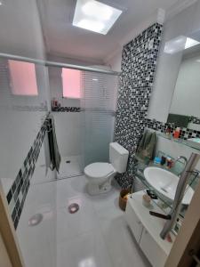 un bagno bianco con un water e un lavandino di Jasmim 12 a Santo André