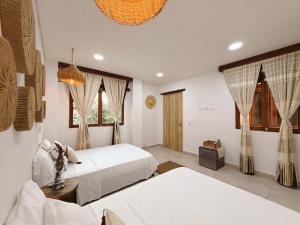 En eller flere senge i et værelse på Hotel Boutique de playa - Casa Solhu