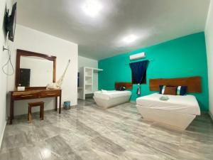 a bathroom with a tub and a sink and a mirror at Jungla maya hotel in Bacalar