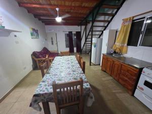 a dining room with a table and a kitchen at La fragata estadias in San José