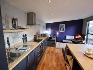a kitchen with a counter and a living room at Narrowgate Castle Ocean Blue Lodge Central Alnwick Inc Sofa Bed in Alnwick