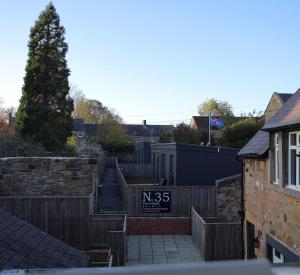 a sign on a fence in a residential neighborhood at Narrowgate Castle Ocean Blue Lodge Central Alnwick Inc Sofa Bed in Alnwick