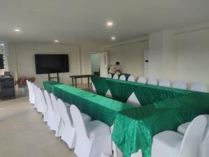 a row of green and white chairs in a room at Verdant Villas in Kaybagal +21 photos