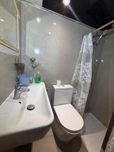 a bathroom with a sink and a toilet and a shower at SleepEasy Harrow in Harrow Weald +8 photos