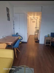 un soggiorno con tavolo e sedie blu di Vue Panoramique a Puteaux