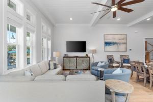 a living room with a couch and a tv at Sunset Key in Inlet Beach