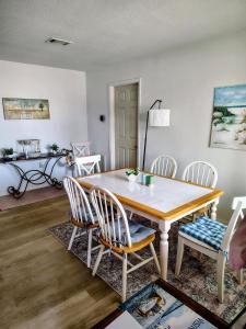 a dining room with a wooden table and chairs at Seagull`s Rest in Navarre