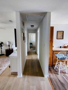 a hallway leading to a living room with white walls at Seagull`s Rest in Navarre