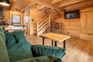 a living room with a couch and a table at Drewniane Zacisze in Biały Dunajec