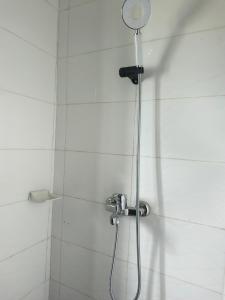 a shower with a shower head in a bathroom at Résidence meuble in Abidjan +4 photos