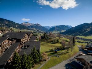 an aerial view of a village with mountains in the background at HUUS Gstaad in Gstaad