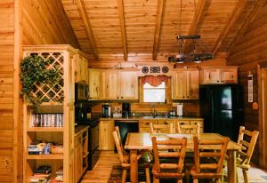 a wooden kitchen with a table and a refrigerator at Creekside Oasis! in Stanton