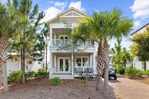 a white house with palm trees in front of it at It's a Shore Thing in Inlet Beach