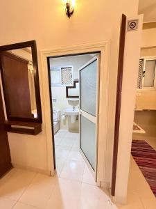 a bathroom with a door leading to a toilet at Kabeel's House in Dahab +16 photos