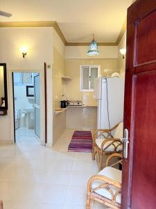 a living room with a refrigerator and a kitchen at Kabeel's House in Dahab